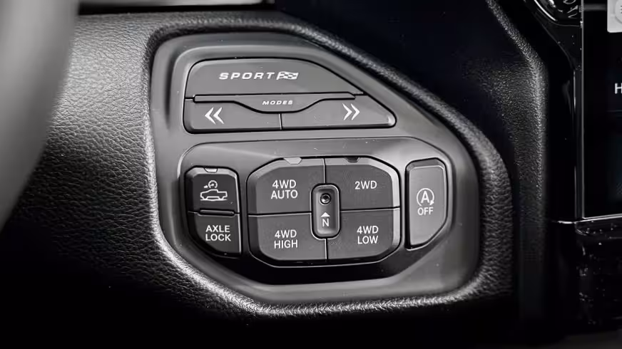 Close-up of the 2026 Ram 1500 Rebel X drive mode selector with options for 2WD, 4WD Auto, 4WD High, 4WD Low, Axle Lock, and Sport mode.