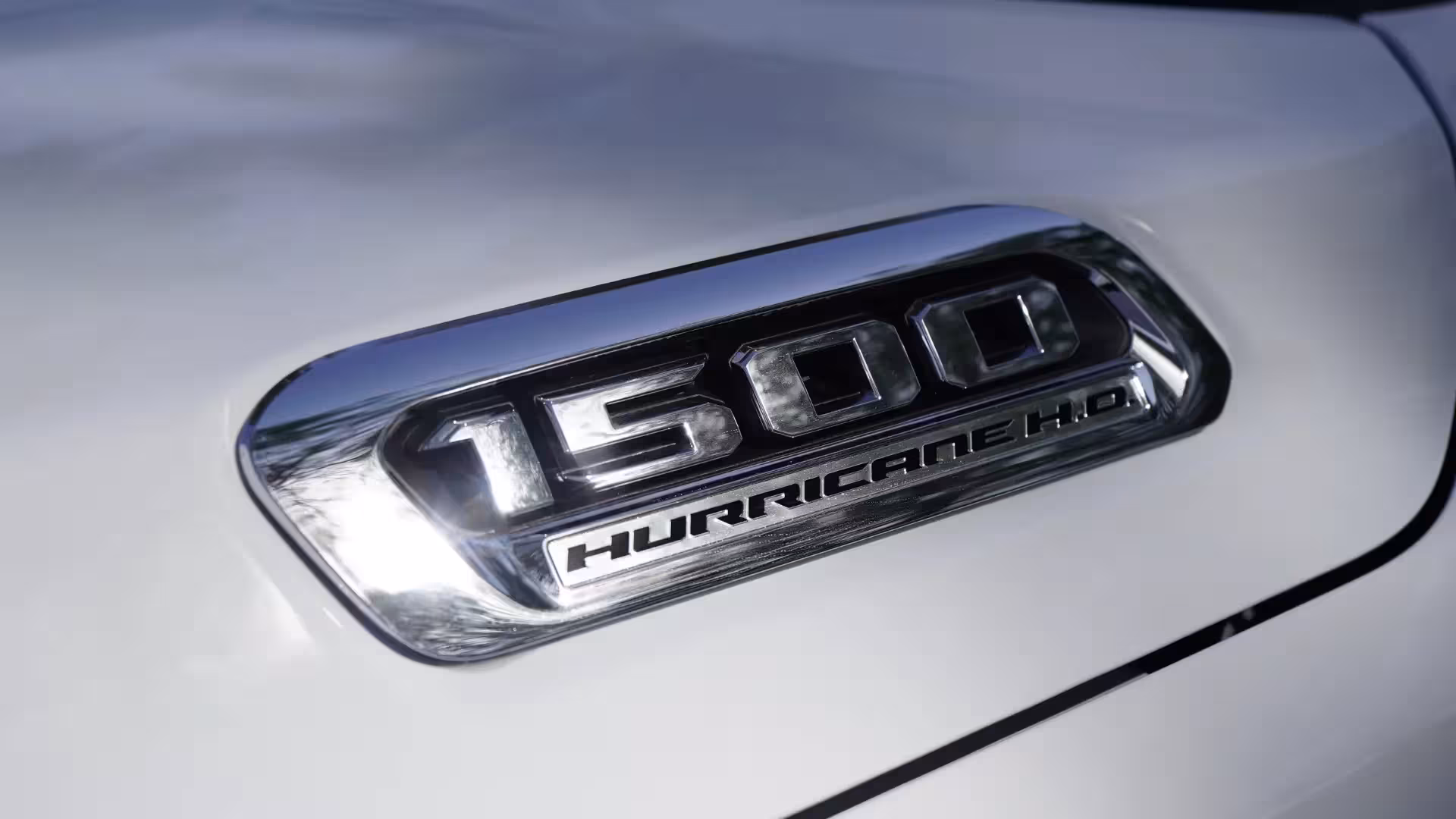 Close-up of a chrome '1500 HURRICANE H.O.' badge on the hood of the 2026 Ram 1500 Longhorn.