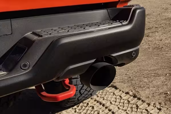 Close-up of the Class-Exclusive dual wireless charging pads in the 2027 Ram TRX, with two smartphones actively charging.