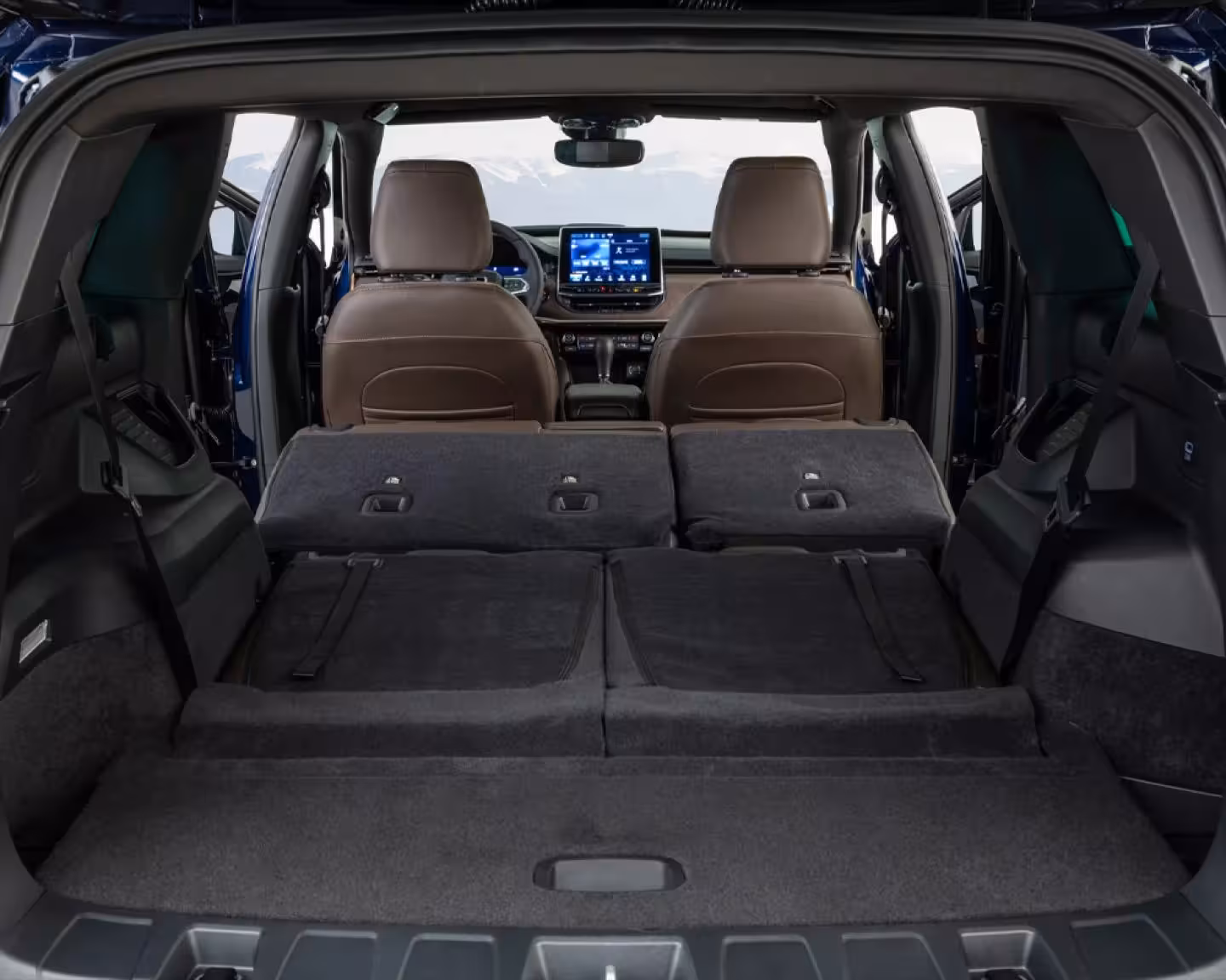A light silver Jeep Commander SUV with a black roof and multi-spoke alloy wheels, presented from a front three-quarter view on a paved road, showcasing its sleek yet robust exterior design.