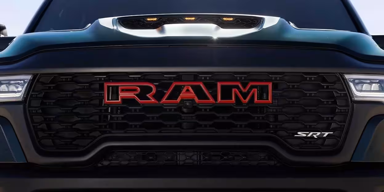 Diagram illustrating Evasive Steering Assist, showing a red 2027 Ram TRX intelligently steering into an open lane to avoid a potential frontal collision with other vehicles.