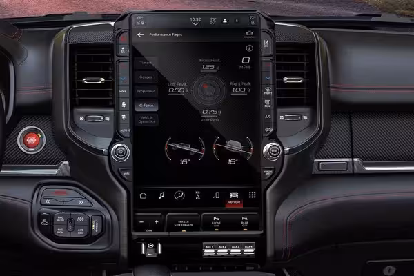 A hand holding a smartphone displaying the Ram Digital Key interface, with a red 2027 Ram TRX in the background on a dirt track, highlighting the smart key functionality.