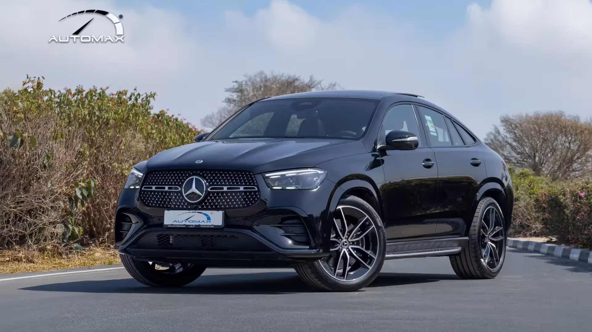 Front three-quarter view of a white 2026 Mercedes-Benz GLE 450 Coupe AMG with AMG styling, 22-inch wheels, and prominent grille.