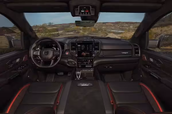 Close-up of a Harman Kardon speaker grille on the interior door panel of the 2027 Ram TRX, showcasing the premium audio system's design and branding.