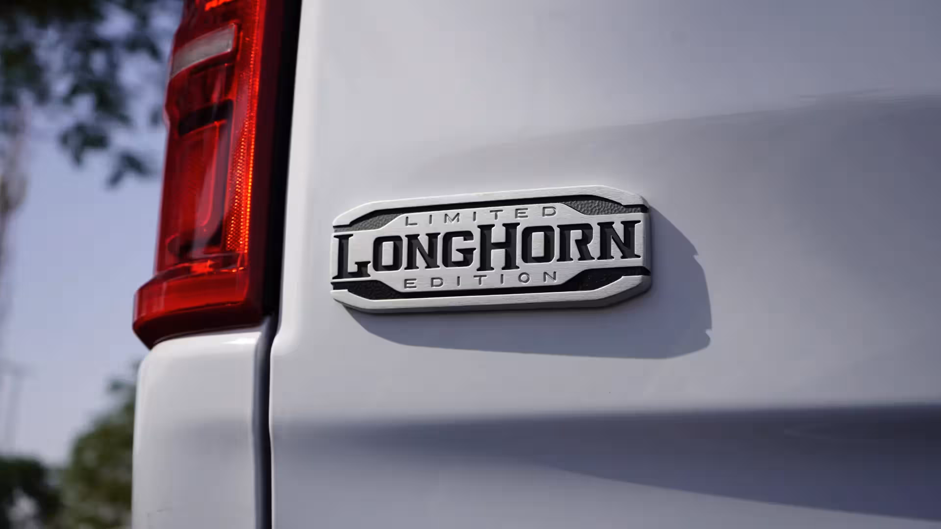 Close-up of the 'LIMITED LONGHORN EDITION' badge on the rear fender of a white 2026 Ram 1500 Longhorn.