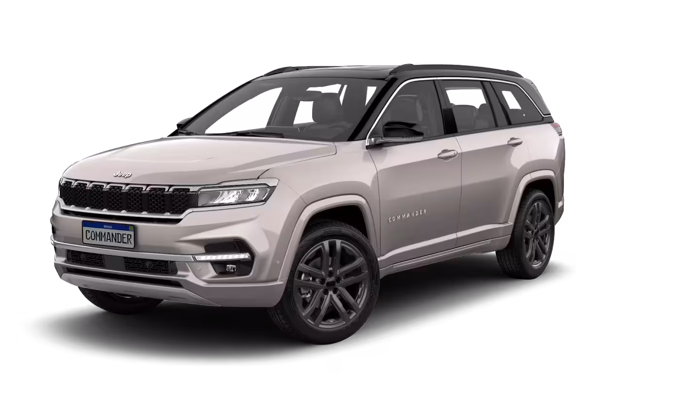 A light silver/beige Jeep Commander SUV from a front three-quarter angle, isolated on a white background, highlighting its elegant design and premium finish, representing the Limited+ trim.
