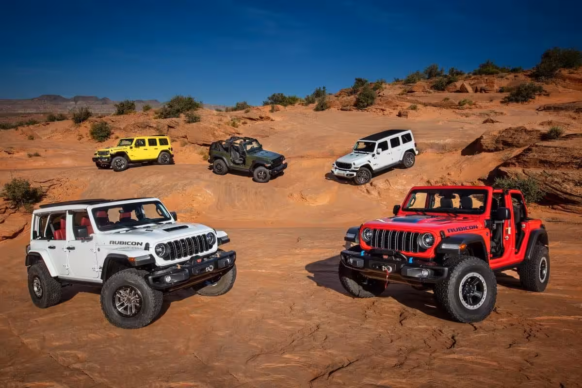 Five diverse Jeep Wrangler models on a red rock landscape