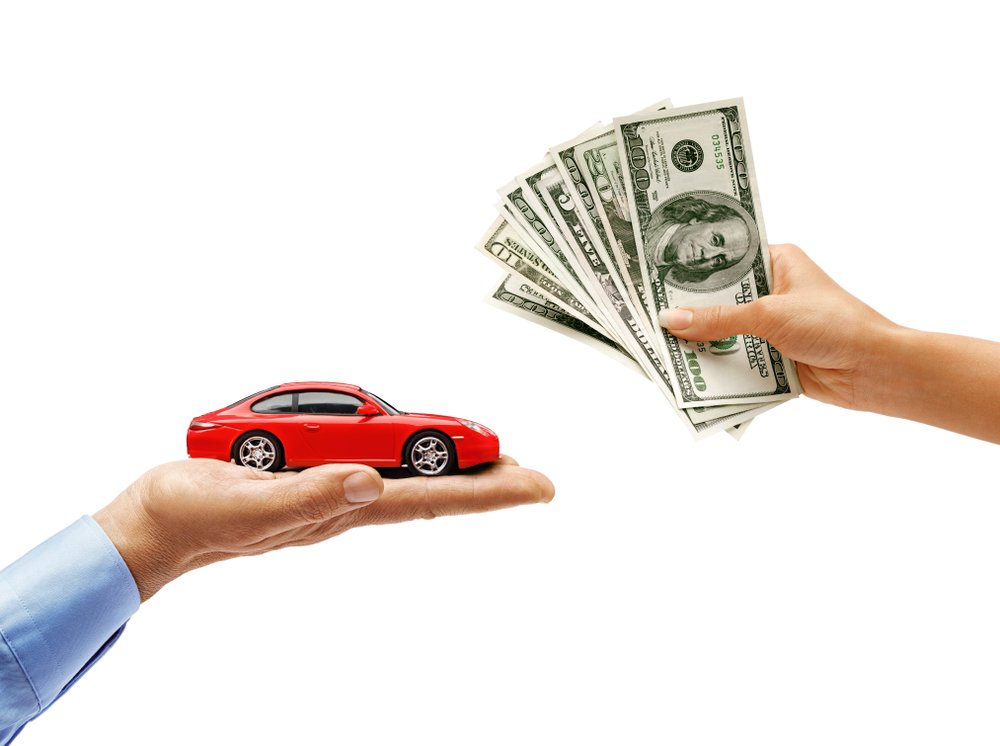 Woman's,Hand,Holding,Money,And,Man's,Hand,Holding,Red,Car